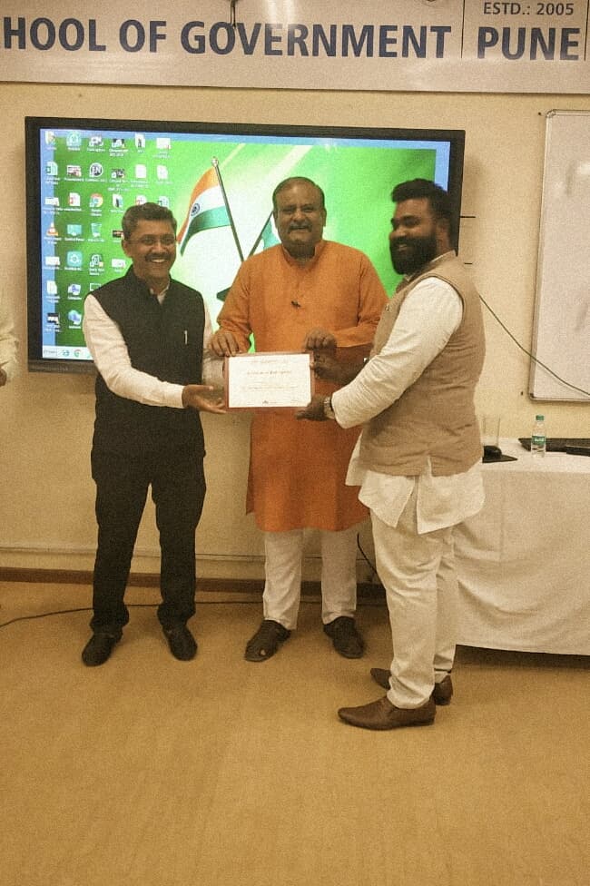 Receiving a certificate at the School of Government, Pune